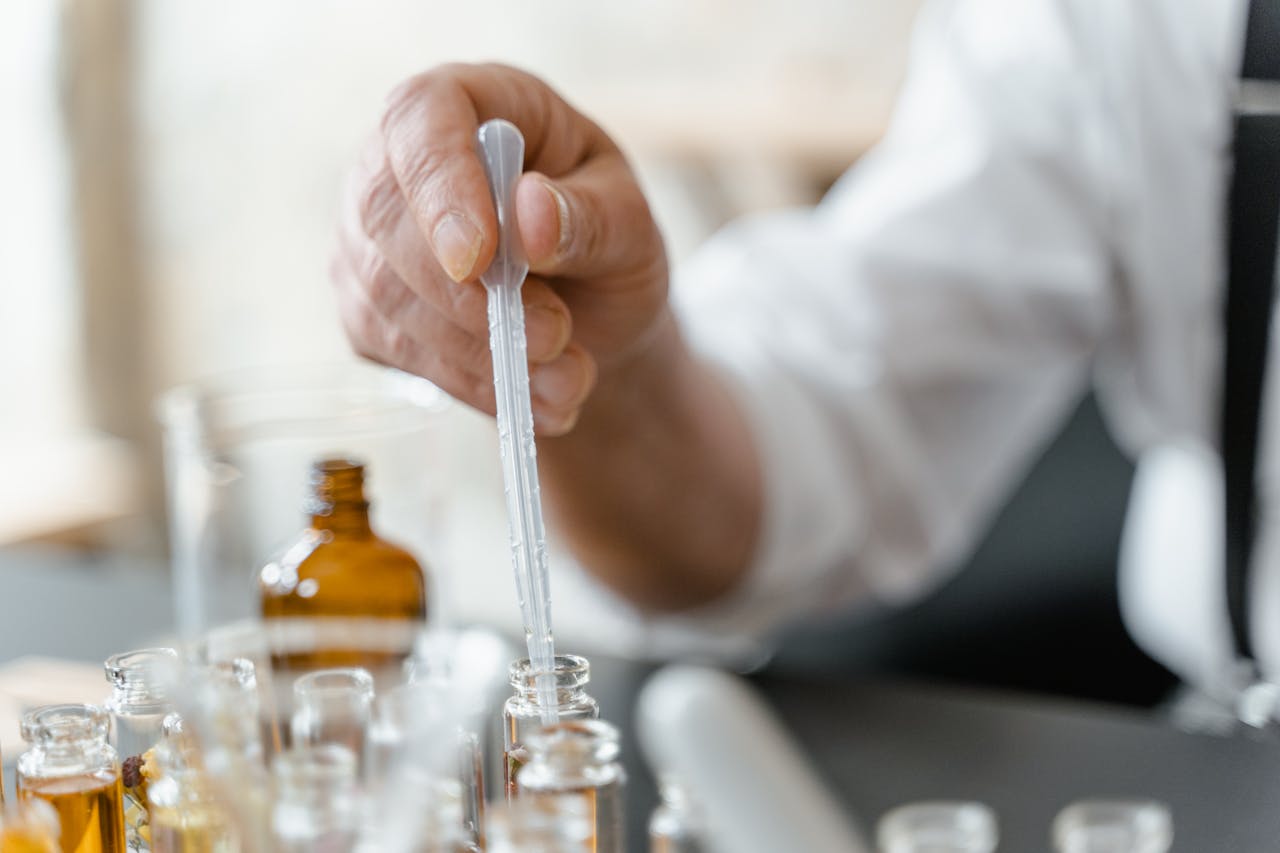 hero-gallery-02 Detailed image of a person mixing essential oils in a laboratory setting.